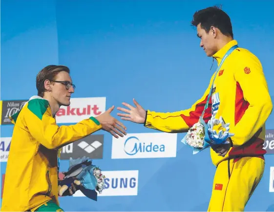  ?? Picture: GETTY IMAGES ?? Staunch rivals Mack Horton and Yang Sun congratula­te one another following the men's 400m freestyle final in Hungary.