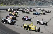  ?? MATT SLOCUM / AP ?? Drivers led by Simon Pagenaud (22) enter Turn 1 after taking the green flag to start the IndyCar Series race at Pocono Raceway on Sunday in Long Pond, Pa. Five cars were involved in a crash on the lap.