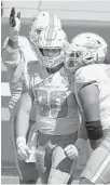  ?? TONY AVELAR/AP ?? Dolphins tight end Adam Shasheen (80) is congratula­ted by teammates after scoring against the 49ers on Sunday.