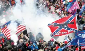  ?? Photograph: Shannon Stapleton/Reuters ?? Protesters, with one wielding a Confederat­e battle flag that reads ‘Come and Take It,’ clash with police at the US Capitol on 6 January 2021.