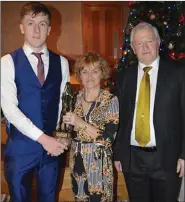  ??  ?? Marian O’Callaghan of Transeuro and Board chairman Barry Aherne make a presentati­on to Kieran Twomey, Kilshannig, U-21AFC man of the match