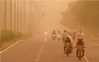  ?? Reuters ?? Commuters make their way amidst haze and dust in Chandigarh on Friday. —