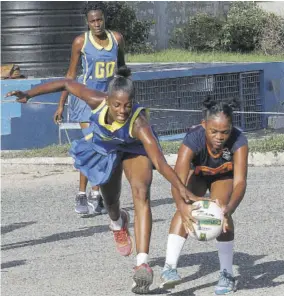  ?? (Photos: Norman Thomas) ?? Ashley Woodhouse (right) of Dunoon Technical grasps the ball ahead of Latoya Wilson of Gaynstead during their ISSA Urban High School Girls Senior League netball match at Dunoon Technical court on Wednesday. Gaynstead won 73-5.