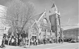  ?? THOMAS SLUSSER/THE TRIBUNE-DEMOCRAT ?? People wait Friday outside St. Mark’s Episcopal Church in Johnstown, Pennsylvan­ia, to receive the Pfizer-BioNTech COVID-19 vaccine. Federal health officials say deaths from COVID-19 in the U.S. are falling again after a surge.