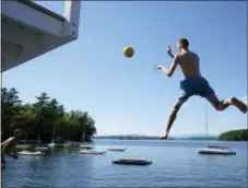  ??  ?? A camper takes a leap off of the 11-foot diving tower.