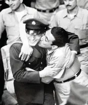  ?? AFP via Getty Images ?? In Homestead on Dec. 25, 1962, a relative kisses a Brigade 2506 member who was freed more than a year after the Bay of Pigs invasion.