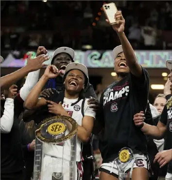  ?? Chris Carlson/Associated Press ?? MiLaysia Fulwiley, left, celebrates with her South Carolina teammates after they won the SEC conference tournament March 10. Fulwiley has been on Dawn Staley’s radar since she was in seventh grade.