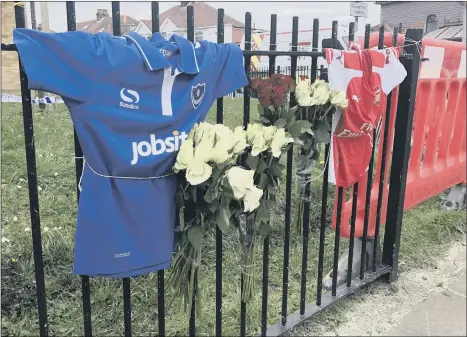  ??  ?? TRIBUTES Two football shirts have been left alongside almost a dozen bouquets of flowers at the site of a fatal crash in Hilsea