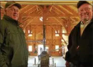  ??  ?? Owner Randy Galusha, left, shows off his new timberfram­e sugarhouse to state agricultur­e Commission­er Richard Ball, right, on Friday at Toad Hill Maple Farm.