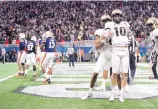  ?? ALBERT CESARE/ASSOCIATED PRESS ?? Central Florida quarterbac­k McKenzie Milton (10) celebrates after scoring a touchdown in Monday’s Peach Bowl victory over Auburn.
