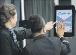  ??  ?? CHECKING IN. Airline gate agents sign into facial recognitio­n verificati­on system VeriScan at Dulles Internatio­nal Airport.