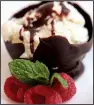  ?? Detroit Free Press/TNS/JESSICA J. TREVINO ?? Chocolate Bowls
are filled with ice cream served with fresh raspberrie­s and mint.