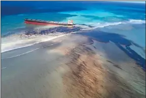  ?? (AP/MU press/Georges de La Tremoille) ?? Oil leaks Friday from the MV Wakashio, a bulk carrier ship that ran aground last month on a reef off the coast of Mauritius.