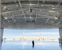  ??  ?? Virgin Galactic ground crew guide the company’s carrier plane into the hangar at Spaceport America following a test flight over the desert near Upham, New Mexico, on Thursday, August 15, 2019.