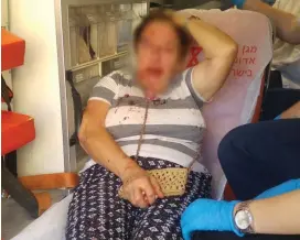  ??  ?? A WOMAN in Kiryat Gat receives emergency care after being attacked last month.