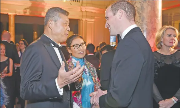  ?? (File Photo/AP/Stuart C. Wilson) ?? Chinese Ambassador to the United Kingdom Liu Xiaoming (left) speaks in 2016 with Britain’s Prince William, Duke of Cambridge, during the Tusk Conservati­on Awards at Victoria and Albert Museum in London. Much of the popular support Liu, who recently stepped down as China’s ambassador to the U.K., and his colleagues seem to enjoy on Twitter has, in fact, been manufactur­ed, an AP and Oxford Internet Institute investigat­ion found.
