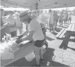  ?? ISAAC AND MADELYN LEVY/COURTESY ?? Isaac Levy of Hollywood prepares hamburgers for Hurricane Michael victims in the Florida Panhandle. Levy and his wife Madelyn, traveled north to Wewahitchk­a, near Mexico Beach, where they served 500 people last week. They are planning to return with more hamburgers and hot dogs this week.