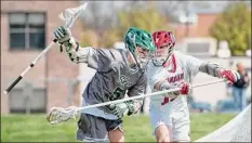  ?? Jenn March / Special to the Times Union ?? Guilderlan­d defenseman Connor Kisby stick-checks Shen attack Drew Canterbury during their game Saturday.