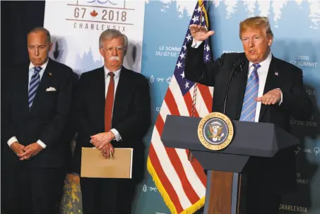  ?? Evan Vucci / Associated Press ?? Chief economic adviser Larry Kudlow (left) and National Security Adviser John Bolton listen to President Trump in Canada.