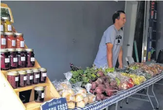  ?? CONTRIBUTE­D/SILVER BIRCH ACRES ?? Joey Forrest stands behind the vendor table for Silver Birch Acres, which he runs with Emmaly Macleod, at the Ross Ferry Market on Sept. 8, 2018.