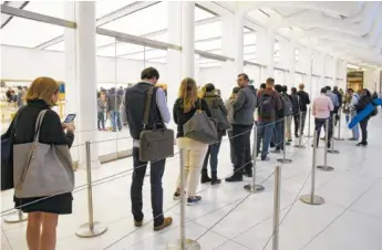  ?? THE ASSOCIATED PRESS ?? Customers wait Friday in line outside of the Apple Store at the World Trade Center to purchase the iPhone X in New York.