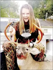  ?? PHOTO SUBMITTED BY AMBER KILLION ?? Ember Killion, 15, of Southwest City, giddily poses with the 8-point 132.25-inch buck she killed with a crossbow during the waking hours of Oct. 5. Killion is a freshman at MCHS. This was her first kill with a crossbow and her first hunt this season.