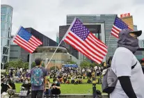  ?? ASSOCIATED PRESS FILE PHOTO ?? Protesters display United States flags during continuing prodemocra­cy rallies Tuesday in Tamar Park, Hong Kong. Such images fuel a Chinese conspiracy theory of covert U.S. nefariousn­ess in the uprising.