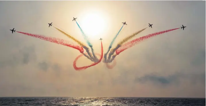  ??  ?? The Red Arrows perform their final manouvre at a display in Jeddah, Saudi Arabia, on their 2017 overseas tour. Below, Flt Lt Tom Bould is welcomed home by his children yesterday