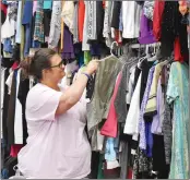  ?? PHOTOS BY STACI VANDAGRIFF/THREE RIVERS EDITION ?? Melissa Cox of Carolyn’s Helping Hands in Searcy helps sort some of the organizati­on’s donated clothes.