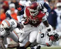  ?? NWA Media/MICHAEL WOODS ?? Arkansas running back Alex Collins (center) rushed for 92 yards against Auburn in last year’s 35-17 loss, but Tigers’ Coach Gus Malzahn said that his team will have to play well to win.