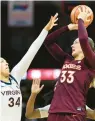  ?? RYAN M. KELLY/GETTY ?? Virginia Tech’s Elizabeth Kitley shoots over London Clarkson on Sunday. Kitley left with a noncontact injury in the third quarter.