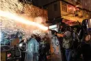  ??  ?? Police fire teargas to clear pro-democracy protesters during a demonstrat­ion on Hungry Ghost festival day in the Sham Shui Po district. Photograph: Anthony Kwan/ Getty Images