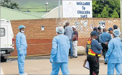  ?? Picture: MICHAEL PINYANA ?? SHOCKING CRIME: Police and investigat­ors at the Ngcobo police station after yesterday’s deadly attack