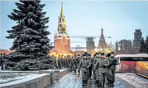  ?? AFP/ GETTY IMAGES ?? Russian servicemen practice at the Kremlin in Moscow on Thursday on the eve of the Final Draw for the 2018 FIFA World Cup.