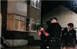  ??  ?? Double killing: Armed police at the scene on Friday night