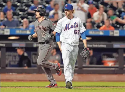  ?? ADAM HUNGER/AP ?? New York Mets pitcher Erik Goeddel (62) reacts after giving up a two-run home run to Diamondbac­ks center fielder A.J. Pollock (11) during the tenth inning of Monday’s game. The Diamondbac­ks won 3-2.