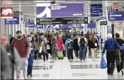  ?? MIGUEL MARTINEZ/AJC 2024 ?? Passengers navigate through Concourse B of Hartsfield­Jackson Internatio­nal Airport, which handled 11.7% more travelers last year than in 2022.
