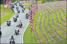  ?? AP ?? Motorcycli­sts ride into Indiantown Gap National Cemetery in Annville, Pa., for a Memorial Day weekend program. Some veterans and loved ones of fallen military members wish the holiday would command more respect.