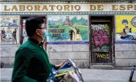  ?? Photograph: Diego Radames/Sopa Images/Rex/Shuttersto­ck ?? A man walks past a closed bar in the Malasaña district of Madrid.