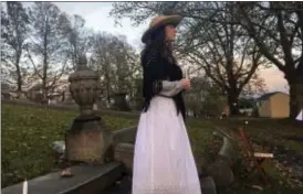  ?? MATTHEW MEDSGER — PITTSBURGH TRIBUNE-REVIEW VIA AP ?? Volunteer Sarah Schott, 41, tells the story of Martha Galbraith, the wife of a Tarentum doctor who died in 1906, as part of the annual Prospect Cemetery Ghost Tour in Brackenrid­ge, Pa.