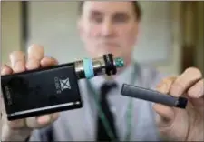  ?? STEVEN SENNE — THE ASSOCIATED PRESS ?? The devices heat liquid into an inhalable vapor that’s sold in sugary flavors like mango and mint, and often with the addictive drug nicotine.