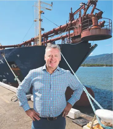  ?? Picture: ANNA ROGERS ?? WELCOME SIGHT: Cairns MP Michael Healy with the suction hopper dredge Balder R.
