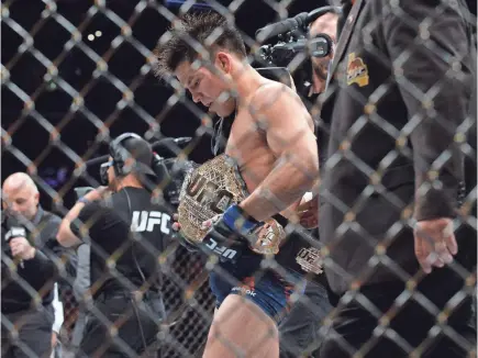  ?? GARY A. VASQUEZ/USA TODAY SPORTS ?? Henry Cejudo celebrates his championsh­ip victory Saturday against Demetrious Johnson at UFC 227 at Staples Center.