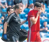  ??  ?? Aberdeen’s Scott Mckenna is forced off with a first-half injury