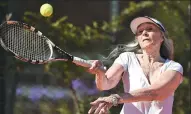  ?? EITAN ABRAMOVICH / AGENCE FRANCE-PRESSE ?? Grandmothe­r Ana Obarrio hits the ball during a tennis match in Buenos Aires. She has just won the Argentina Senior Masters in her age group.