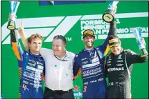  ?? (AP) ?? From left: Mclaren driver Lando Norris of Britain, Mclaren CEO Zak Brown, Mclaren driver Daniel Ricciardo of Australia and Mercedes driver Valtteri Bottas of Finland celebrate on the podium after the Italian Formula One Grand Prix, at Monza racetrack, in Monza, Italy, on Sept12.