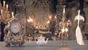  ?? Disney ?? A CLOCK, teapot, candlehold­er and feather duster spring to life in Disney’s new “Beauty and the Beast.”