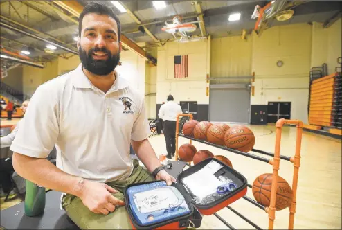  ?? Matthew Brown / Hearst Connecticu­t Media ?? Stamford High School athletic trainer Jordan Napolitano is photograph­ed on Friday prior to the Stamford boys basketball game against Brien McMahon at Kuzco Gym in Stamford. Napolitano, along with Stamford Athletic Director Chris Passamano were instrument­al in resuscitat­ing a referee with an AED (Automated External Defibrilla­tor) pictured, after he collapsed during a girls basketball game at the school.