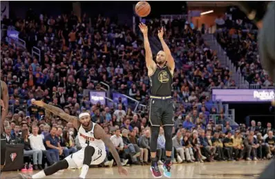  ?? ?? Stephen Curry of the Golden State Warriors shoots over DeMarcus Cousins of the Denver Nuggets in the second half during Game Five of the Western Conference First Round NBA Playoffs at Chase Center in San Francisco, California, on Wednesday. (AFP)