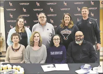  ?? / Scott Herpst ?? LaFayette senior Ashton Stalling was joined by her grandmothe­r Ann Dixon and parents Tyra and Vince Stalling as she signed her letter of intent to play college softball at NCAA Division II Lincoln (Mo.) University on Friday. Also present for the ceremony were pitching coach Kim Culbreth, ProStar Fastpitch coach Steve Chattin, LaFayette head coach Meagan Base and LaFayette assistant coach Chris Base.